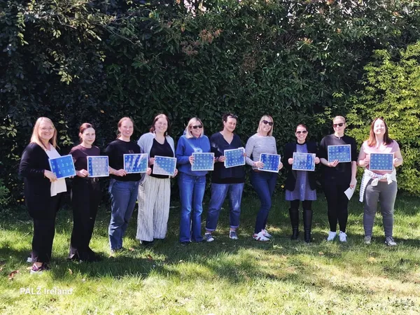 S2C practitioner cohort holding letterboards outdoors